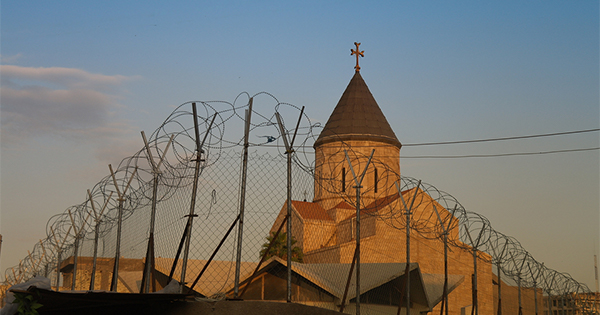 Armenian church behind barbed wire Baghdad, Iraq. (Photo: homocosmicos / Bigstock)