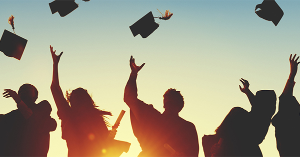 Photo of graduates throwing caps in the air to celebrate. Photo by Rawpixel.com / Bigstock